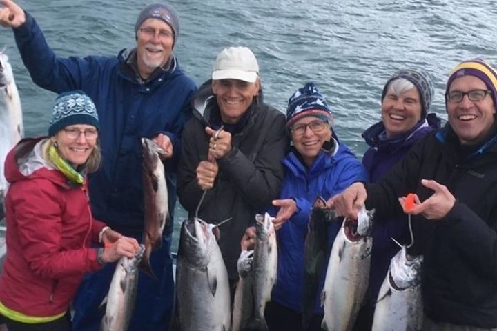 People holding halibut catches