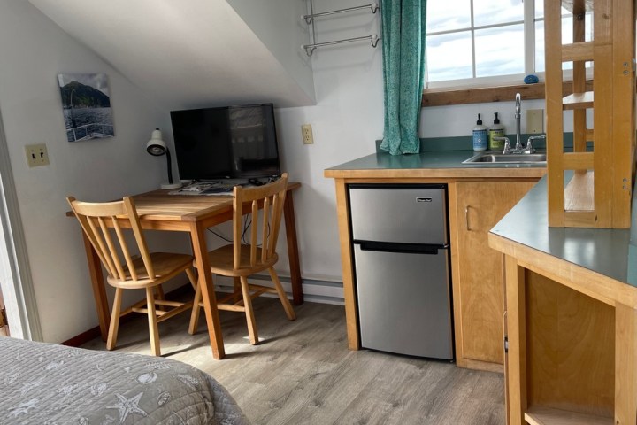 a bedroom with a bed and desk in a room