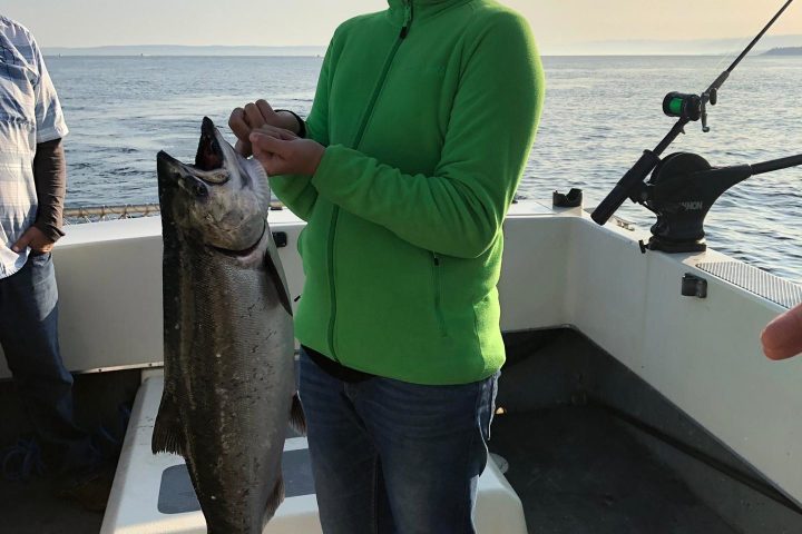 a person holding a fish in the water