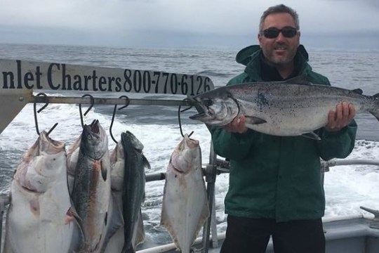 a man holding a fish in the water