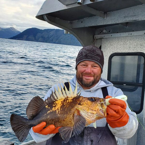 a man holding a bird in the water