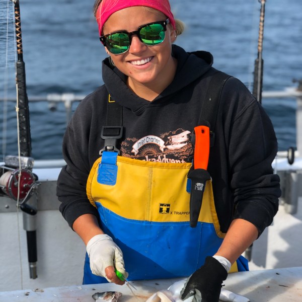 a man holding a fish in the water