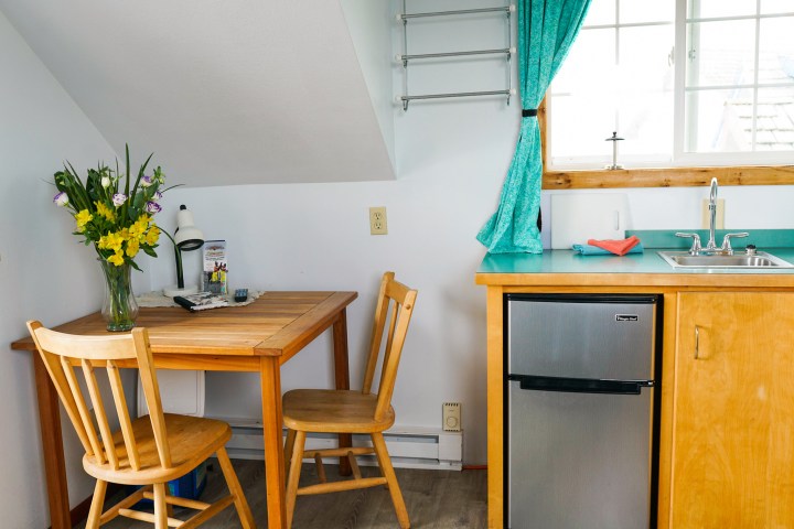 a room filled with furniture and vase of flowers on a table