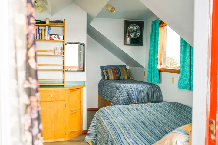 a bedroom with a bed and a chair in a room