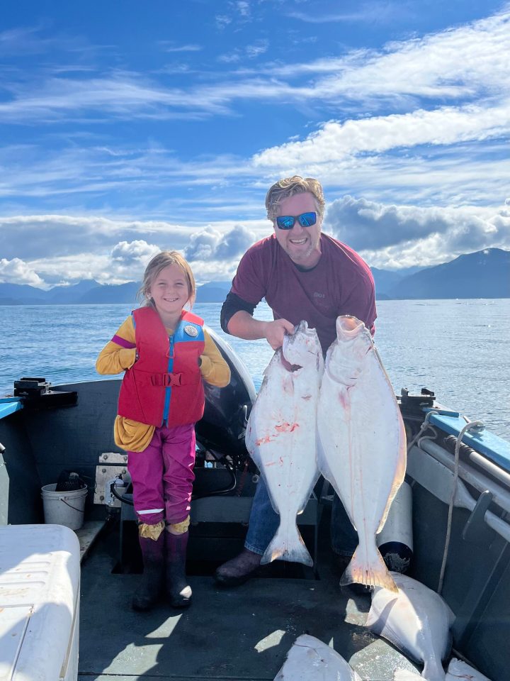 a person holding a fish in the water