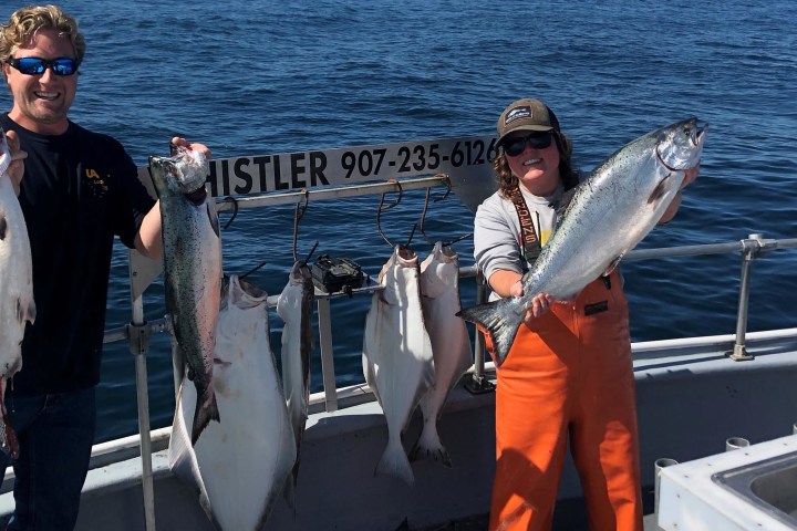 a person holding a fish on a boat