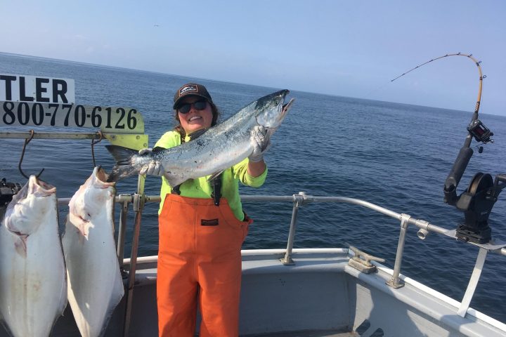 a man holding a fish on a boat