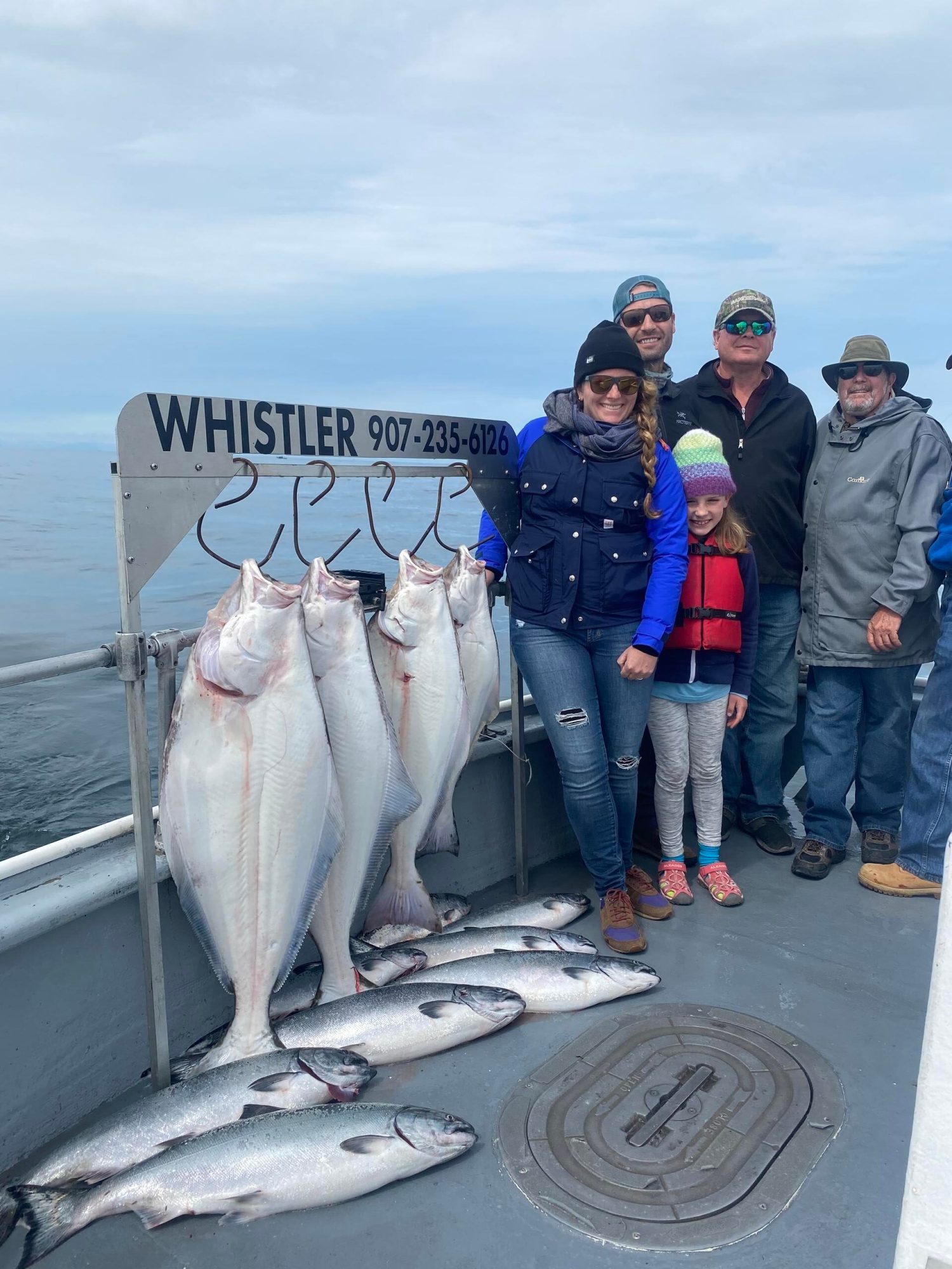 a group of people standing in front of a fish
