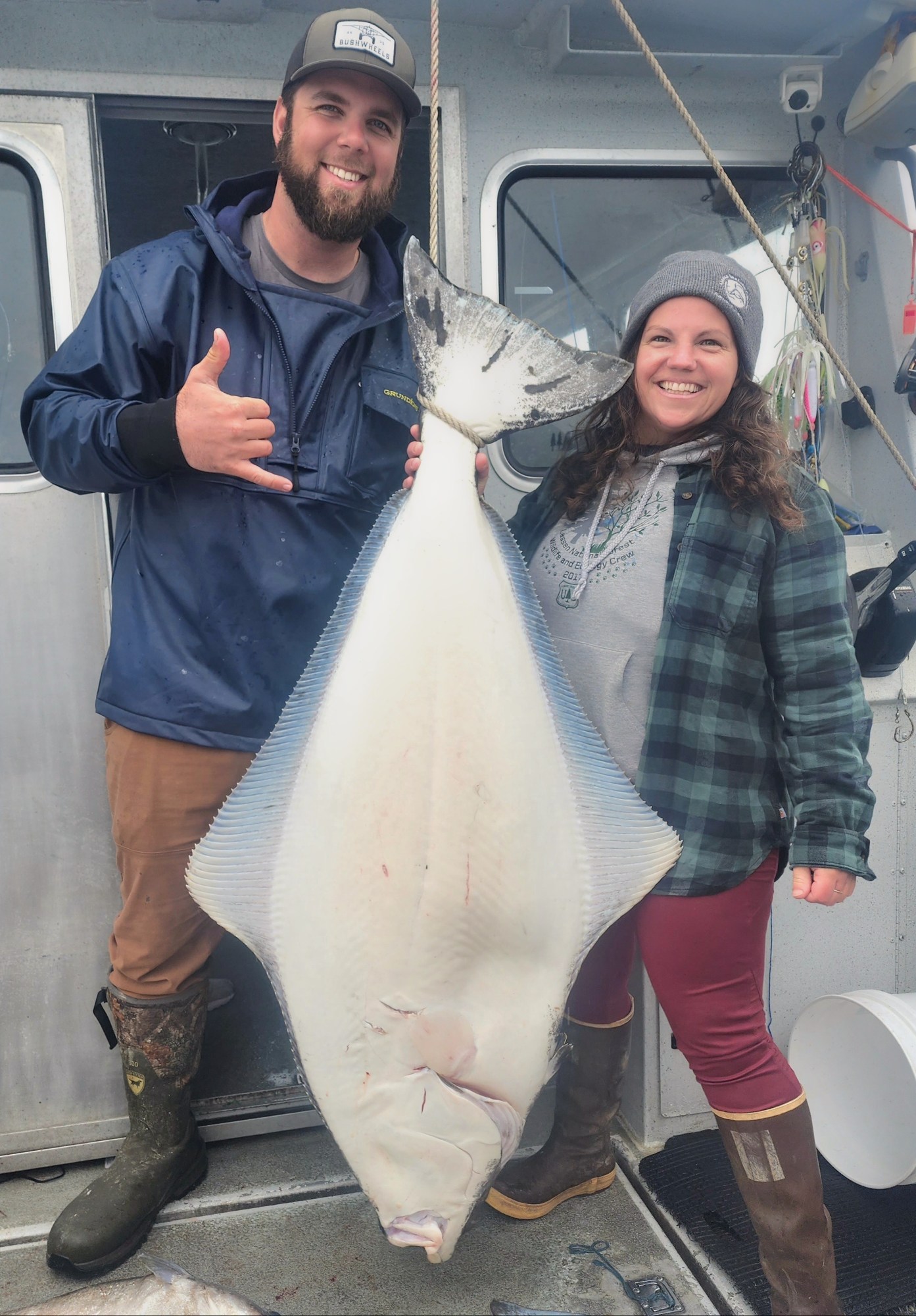 a person holding a fish posing for the camera